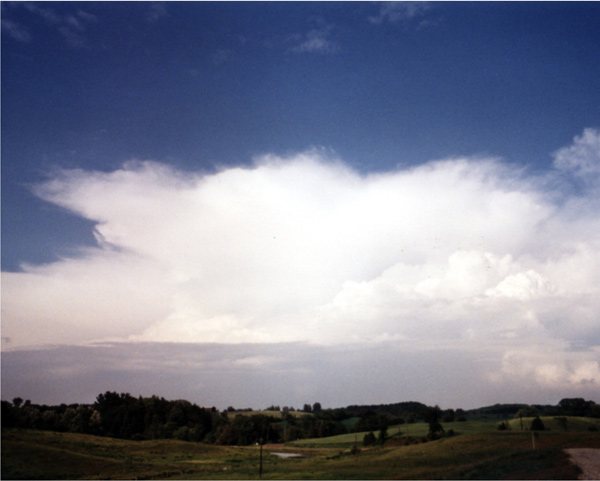 A cumulonimbus cloud in the distance with an anvil