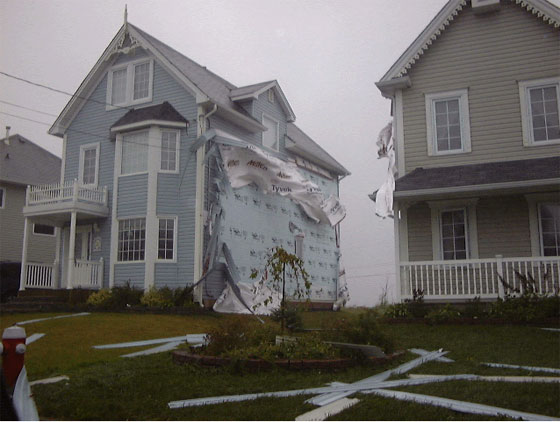 Vinyl sliding was shredded off these houses in Cole Harbour. Photo: Ian Hickey