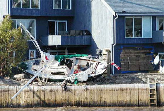 The storm surge tosses this sailboat into a house along the Bedford Basin. Photo: Roger Percy and Andre Laflamme